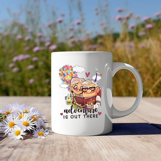 White mug with cartoon design of an old couple and 'adventure is out there' text.